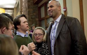 Cardinals first baseman Albert Pujols is greeted by Ethan Schroeder (left), of Eureka,, and Isabel Hogan (center) of St. Louis during an opening reception Wednesday evening for the Albert Pujols Wellness Center for Adults with Down Syndrome at St. Luke's Desloge Outpatient Center in Chesterfield. (Photo by Whitney Curtis/P-D)