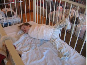MDRI investigators found this young child with Down's Syndrome, in Subotica Children's Institution, restrained to prevent "self abuse" - a product of mind-numbing boredom and lack of human contact. Photo MDRI 2006.
